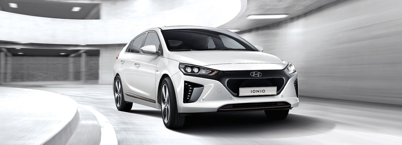 Side front view of white Ioniq Electric parked outside
